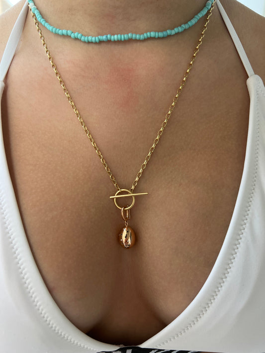 Lucky beginning egg charm with black and white diamonds in pink solid gold