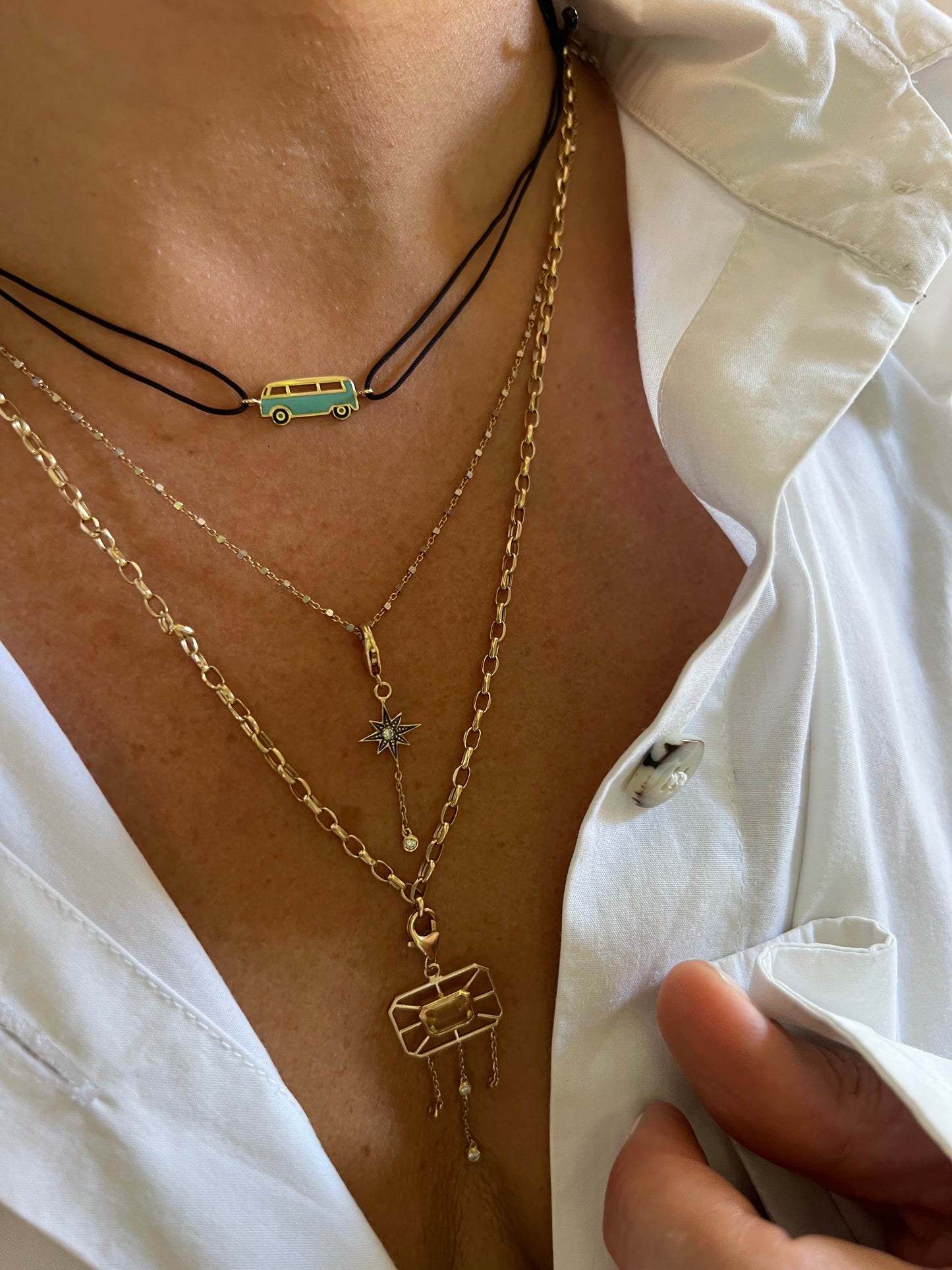 Enamel mini pastel blue Bus necklace with a black cord and yellow gold