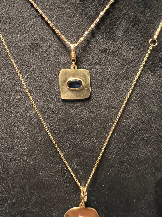 Semi matte finish square charm with a blue sapphire in yellow gold