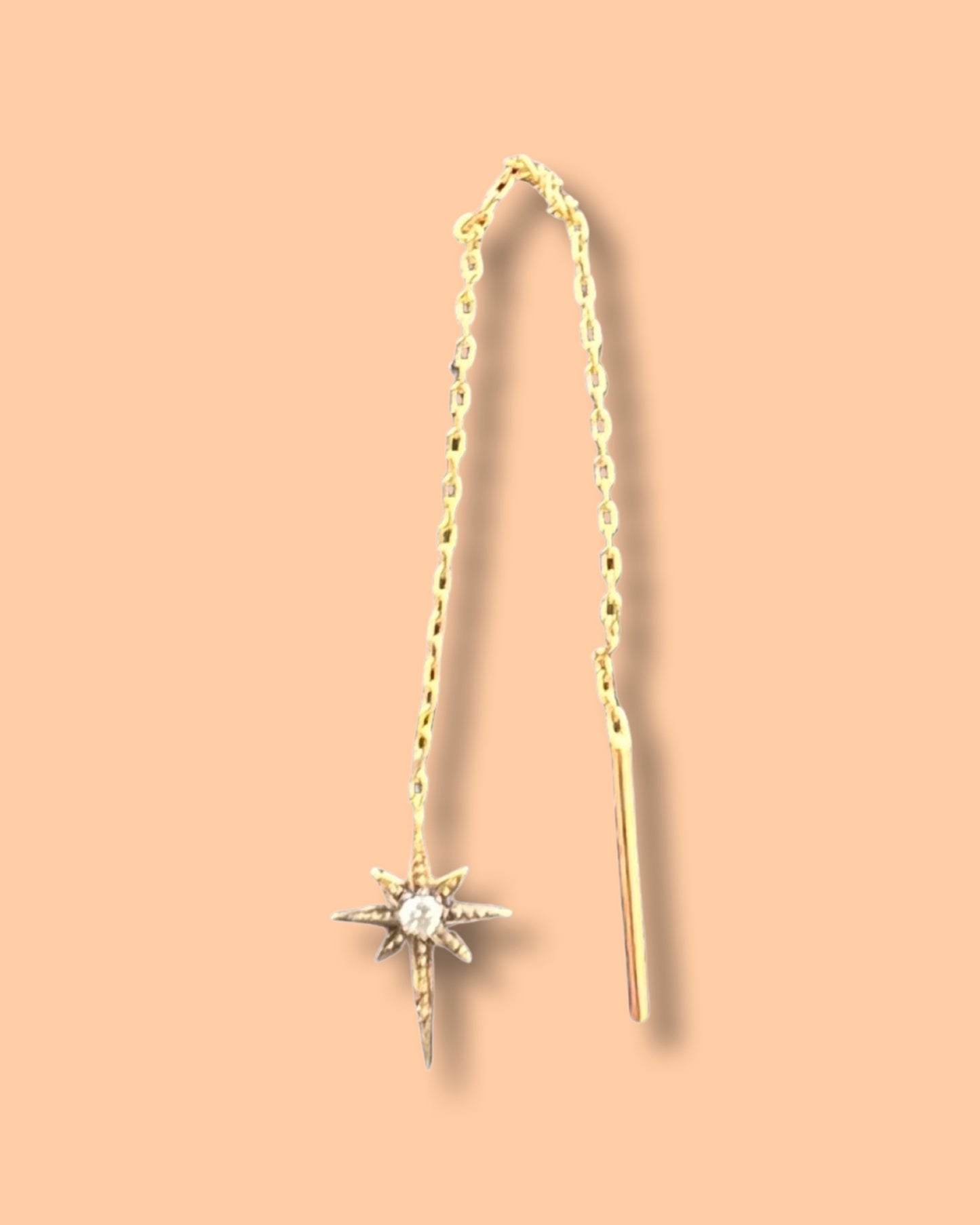 Double chain star earring with a diamond in yellow gold