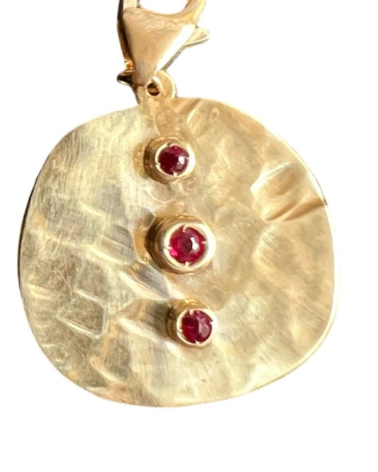 Coin charm with rubies