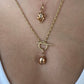 Lucky beginning egg charm with black and white diamonds in pink solid gold